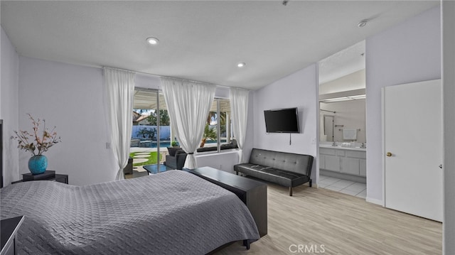 bedroom featuring recessed lighting, wood finished floors, ensuite bathroom, and vaulted ceiling