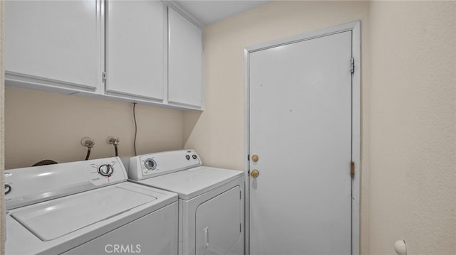 laundry room with cabinet space and separate washer and dryer