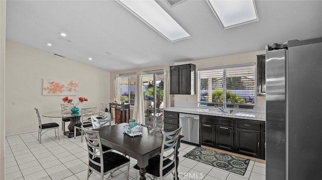 dining room with recessed lighting, light tile patterned flooring, and vaulted ceiling