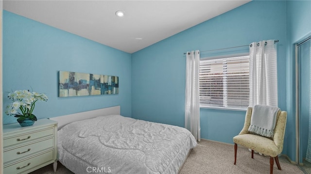 bedroom featuring lofted ceiling and carpet floors