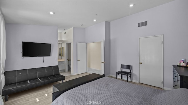 bedroom featuring visible vents, connected bathroom, baseboards, recessed lighting, and wood finished floors