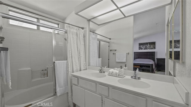 bathroom featuring vaulted ceiling, connected bathroom, shower / bathtub combination with curtain, and a sink