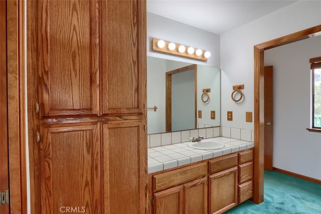 bathroom featuring vanity and baseboards