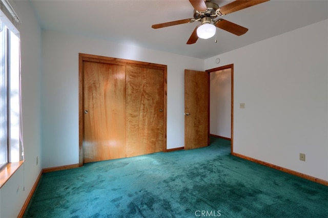 unfurnished bedroom with a closet, carpet flooring, a ceiling fan, and baseboards