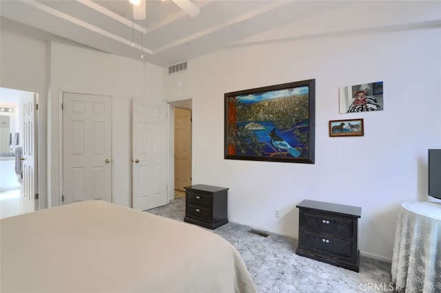 carpeted bedroom featuring a raised ceiling, visible vents, and baseboards