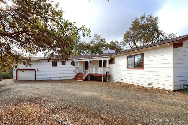 ranch-style home with crawl space, driveway, a garage, and a chimney