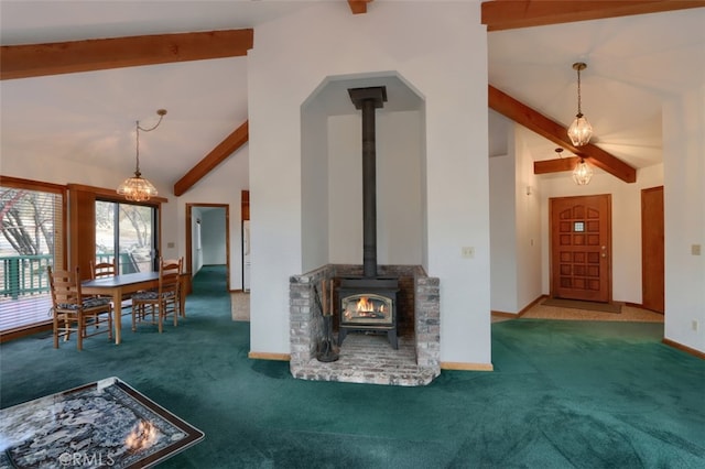 unfurnished living room featuring a wood stove, carpet flooring, high vaulted ceiling, beamed ceiling, and baseboards