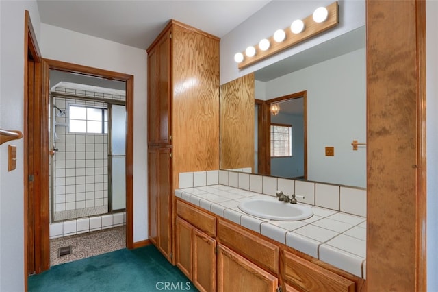 bathroom featuring visible vents, a stall shower, and vanity