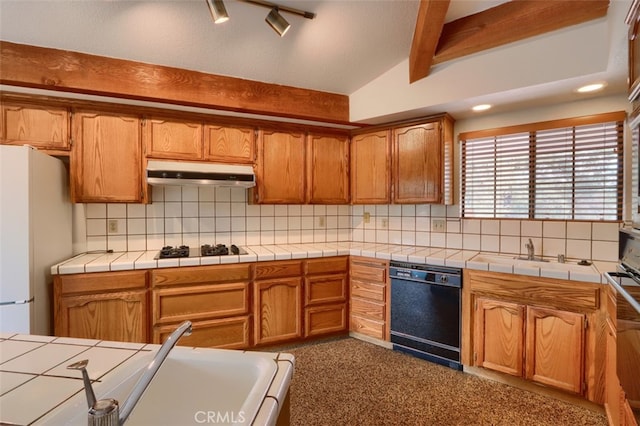 kitchen with lofted ceiling with beams, decorative backsplash, a sink, under cabinet range hood, and black appliances