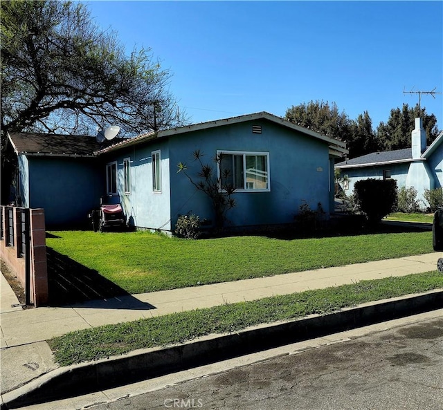 view of home's exterior with a lawn and stucco siding