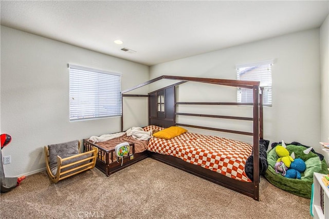 bedroom with visible vents and carpet floors