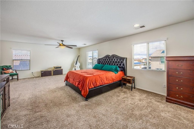 bedroom with baseboards, visible vents, carpet floors, and ceiling fan