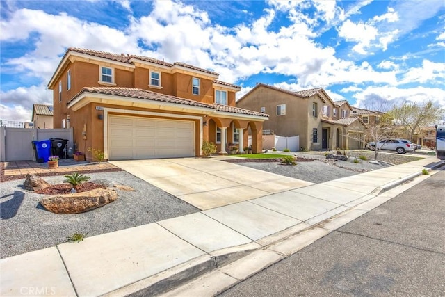 mediterranean / spanish home with fence, a garage, driveway, and stucco siding