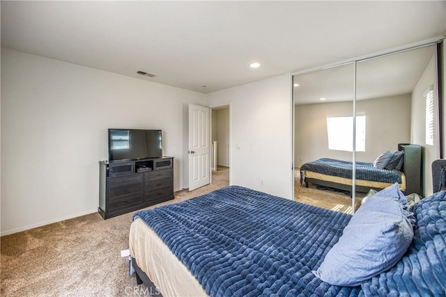 bedroom featuring visible vents, baseboards, recessed lighting, a closet, and light colored carpet