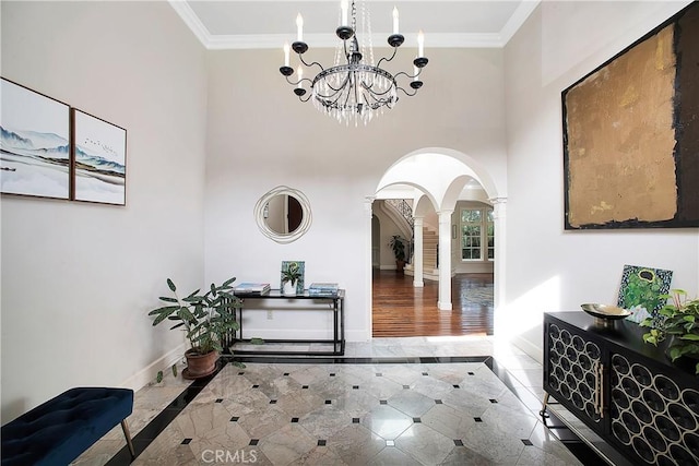 hall featuring ornamental molding, arched walkways, ornate columns, and baseboards