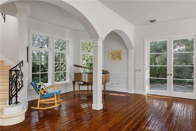 interior space with stairs, visible vents, arched walkways, and crown molding