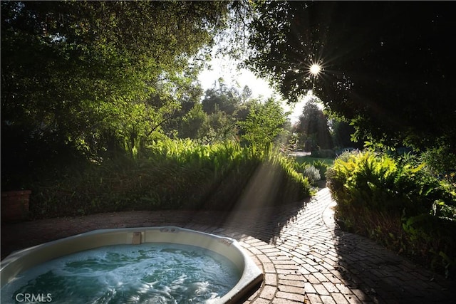 view of pool with an outdoor hot tub