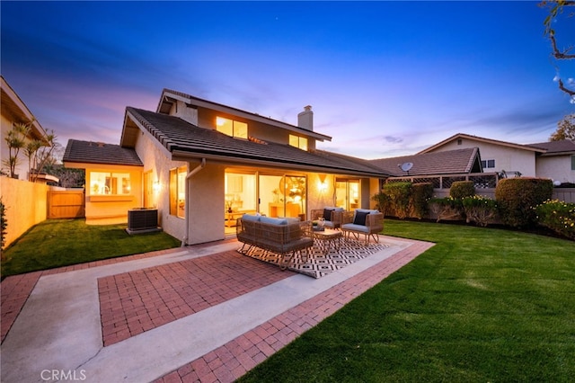 rear view of property featuring fence private yard, central AC unit, an outdoor hangout area, a yard, and a patio area