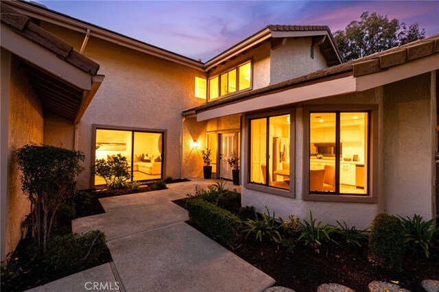 exterior space with a patio area and stucco siding