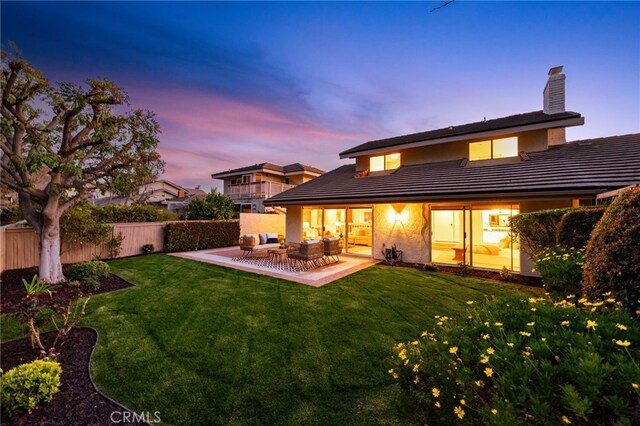 back of house featuring a patio area, a yard, fence, and an outdoor living space