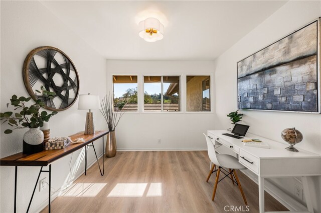 home office featuring light wood-style floors and baseboards