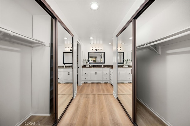 spacious closet with light wood finished floors