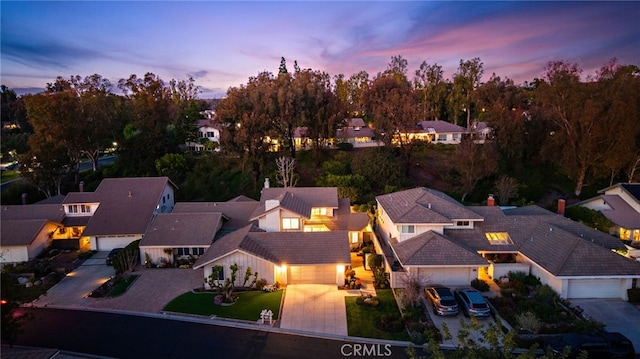 aerial view at dusk featuring a residential view