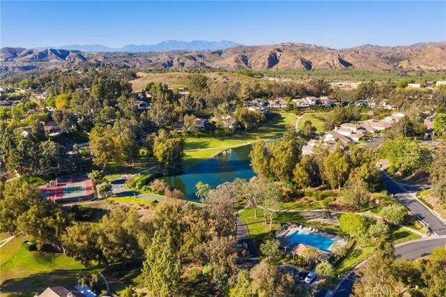 birds eye view of property featuring a water and mountain view