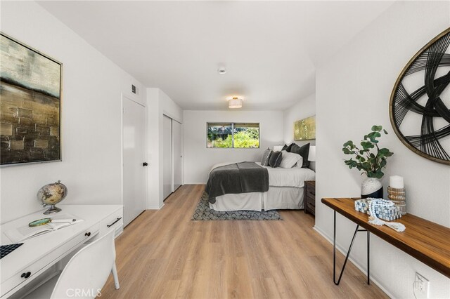 bedroom featuring visible vents and light wood finished floors