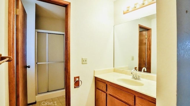 bathroom featuring a stall shower and vanity