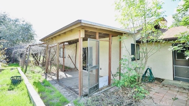 exterior space featuring stucco siding