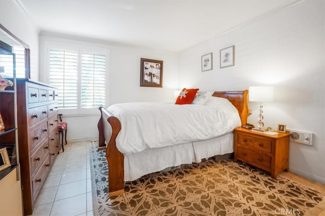 bedroom with light tile patterned floors and ornamental molding