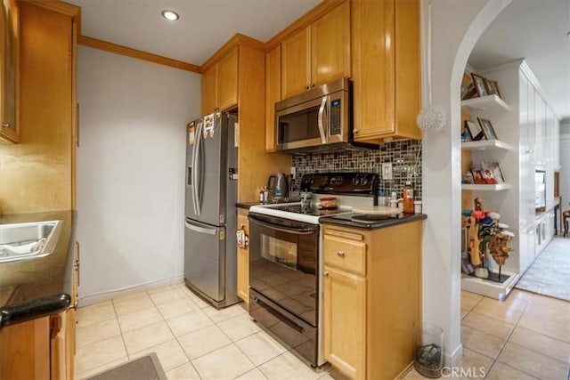 kitchen with light tile patterned floors, dark countertops, stainless steel appliances, crown molding, and backsplash