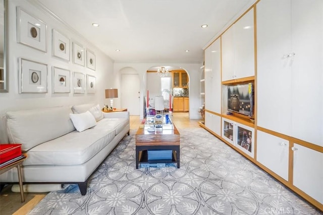 living area with arched walkways and recessed lighting