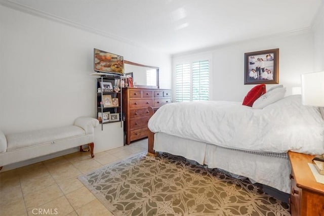 bedroom featuring light tile patterned flooring and crown molding