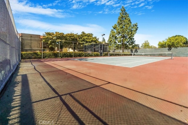 view of tennis court with fence