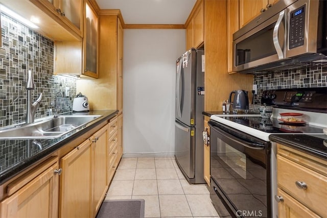 kitchen featuring dark countertops, light tile patterned floors, appliances with stainless steel finishes, and backsplash