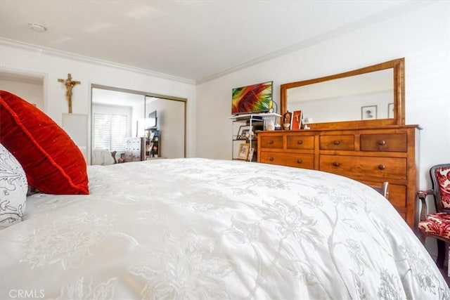 bedroom with a closet and crown molding