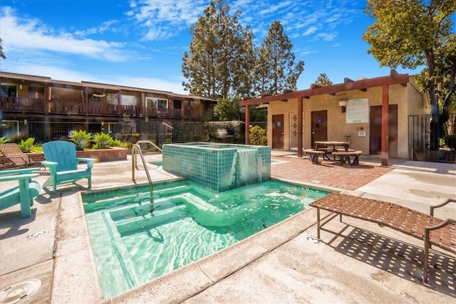 community pool with a community hot tub, a patio area, and fence