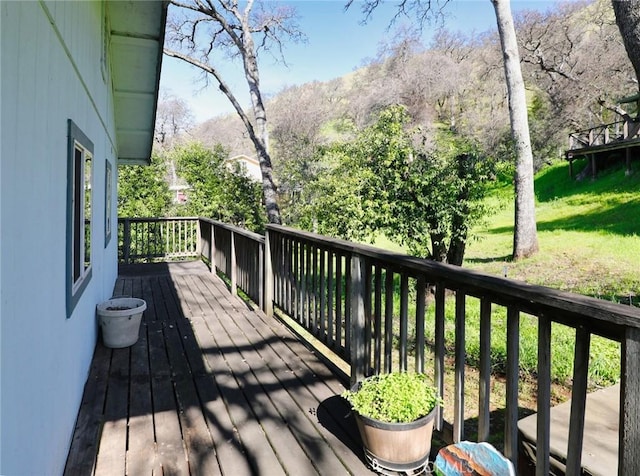 wooden deck with a lawn