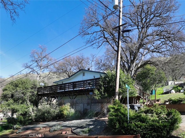 view of side of home with a wooden deck and stairs