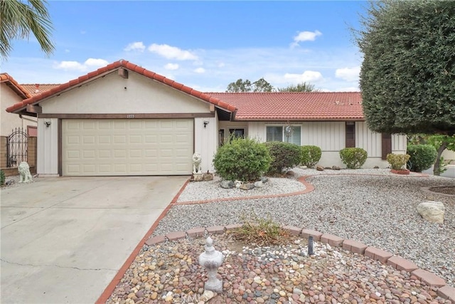 single story home featuring driveway, an attached garage, and a tile roof