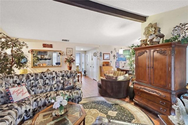 tiled living area featuring vaulted ceiling with beams, visible vents, and a textured ceiling