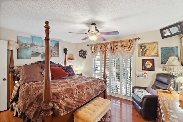 bedroom featuring access to exterior, ceiling fan, a textured ceiling, and wood finished floors