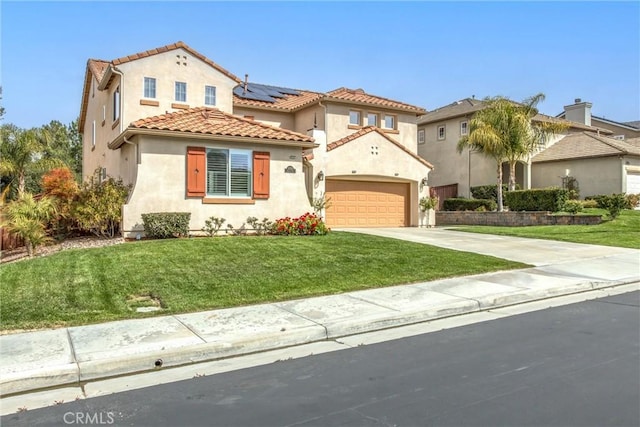 mediterranean / spanish house with driveway, a tiled roof, an attached garage, a front yard, and stucco siding