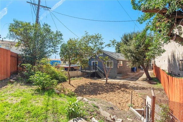 view of yard with a fenced backyard and a deck