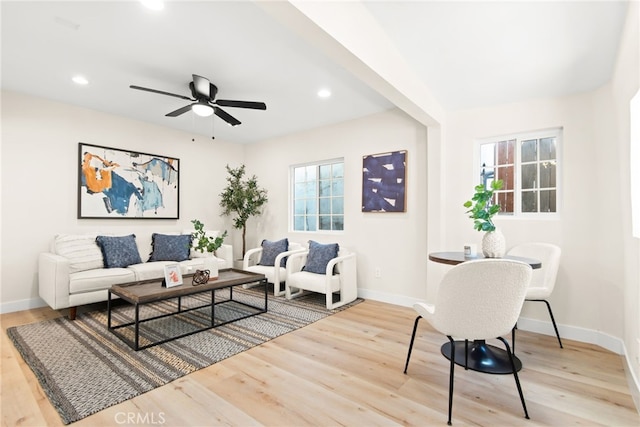 living room with recessed lighting, baseboards, and wood finished floors