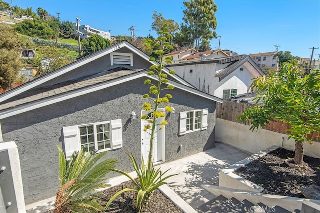 exterior space featuring fence, a patio, and stucco siding