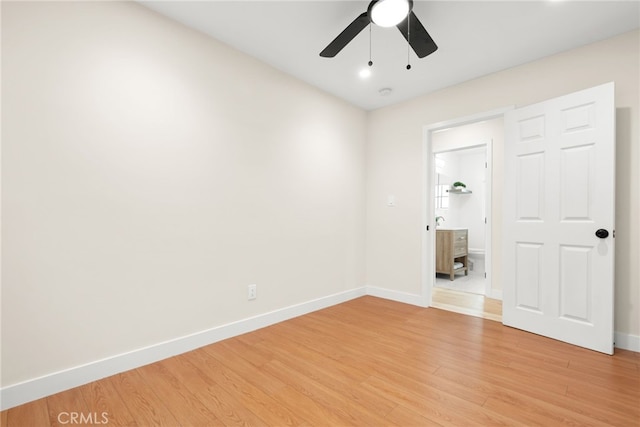 spare room with light wood-style flooring, baseboards, and a ceiling fan