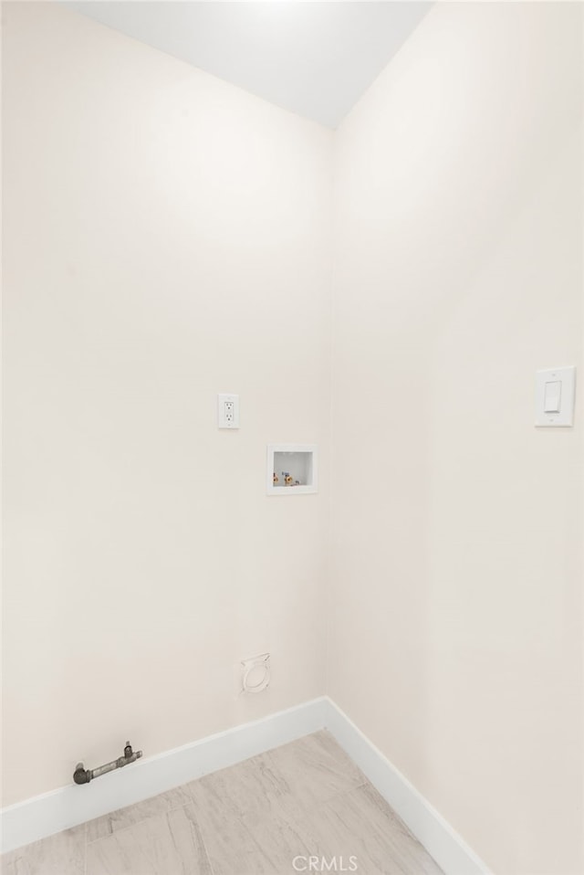 washroom with hookup for a gas dryer, baseboards, laundry area, and washer hookup